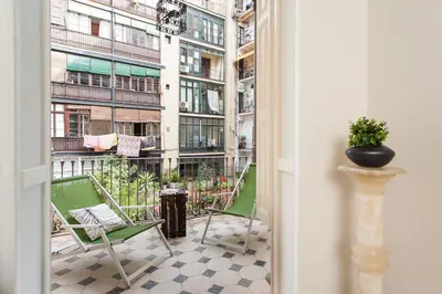 a balcony with chairs and a view of a building at Catalan Music Palace with private terrace in Barcelona