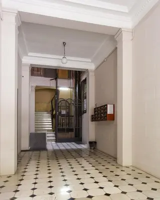 an empty hallway with a door and a tiled floor at Catalan Music Palace with private terrace in Barcelona