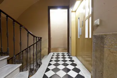 a hallway with a black and white checkered floor at Great location with private terrace in Barcelona