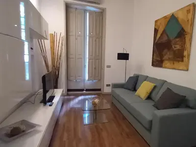 a living room with a couch and a tv at Great location with private terrace in Barcelona