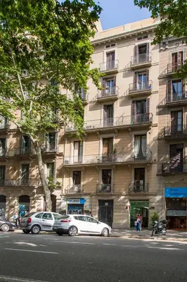 a large building with cars parked in front of it at Great location with private terrace in Barcelona