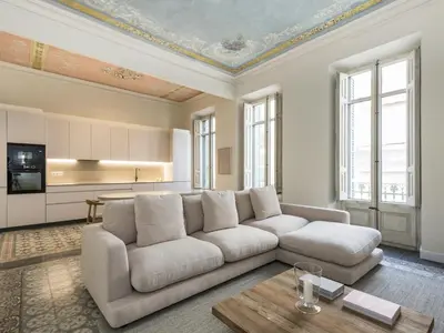 a living room with a couch and a table at The Residences At Bartomeu 26 Suite Bartomeu in Sitges