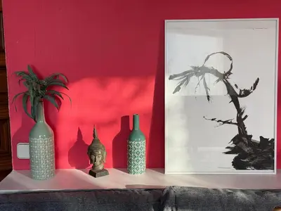 a group of vases sitting on a shelf against a red wall at Barcelona Attic center 2 Terraces Magic views in Barcelona