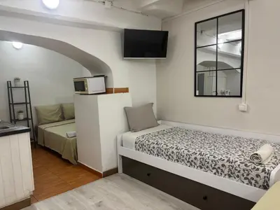 a small room with a bed and a microwave at 019 principal floor in Barcelona