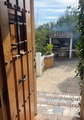 an open door to a patio with a grill at Villa Agaporni in Senmanat