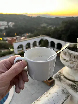 a person holding a cup with a spoon in their hand at Villa Agaporni in Senmanat
