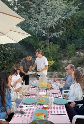 a group of people sitting around a long table at Villa Agaporni in Senmanat