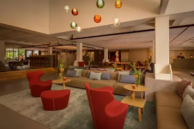 a lobby with a couch and tables and chairs at Ohla Eixample in Barcelona