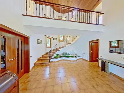 a large living room with a staircase and wooden floors at PREMIUM HABITAT Can Ferrer in Arenys de Munt