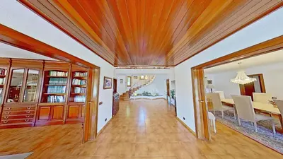 a dining room and living room with a wooden ceiling at PREMIUM HABITAT Can Ferrer in Arenys de Munt