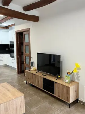 a living room with a large flat screen tv at La Casa Vella