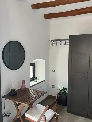 a dining room with a wooden table and a mirror at La Casa Vella