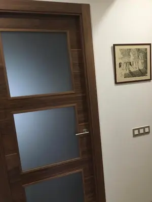a glass door with a wooden frame in a room at La Casa Vella