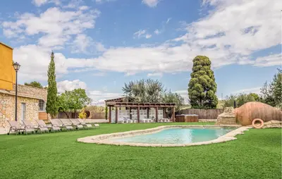 a backyard with a swimming pool and a gazebo at Gorgeous Home In Olerdola With Private Swimming Pool, Can Be Inside Or Outside in Olerdola