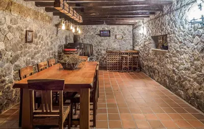a tasting room with a wooden table and chairs at Gorgeous Home In Olerdola With Private Swimming Pool, Can Be Inside Or Outside in Olerdola