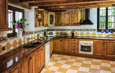a large kitchen with wooden cabinets and a sink at Gorgeous Home In Olerdola With Private Swimming Pool, Can Be Inside Or Outside in Olerdola