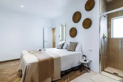 a white bedroom with a bed and a shower at En Ville Boutique Apartments Boqueria Market in Barcelona
