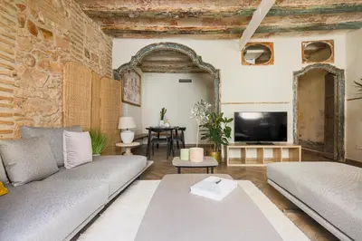 a living room with a couch and a tv at En Ville Boutique Apartments Boqueria Market in Barcelona