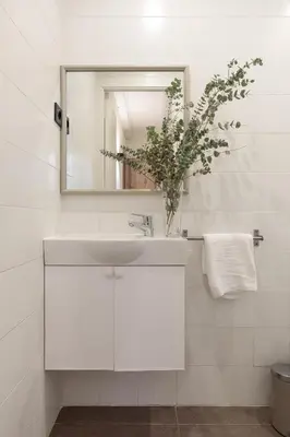a white bathroom with a sink and a mirror at Enjoy Apartments VP Camp Nou 1 in Barcelona