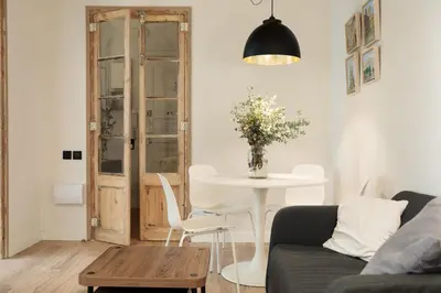 a living room with a table and a couch at Enjoy Apartments VP Camp Nou 1 in Barcelona