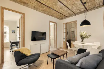 a living room with a couch and a table at Enjoy Apartments VP Camp Nou 1 in Barcelona