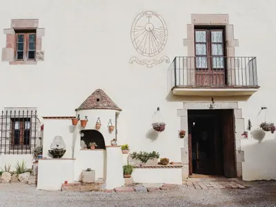 a white building with a door and a window at Apartment Superior-Doppelsuite mit Schlafsofa by Interhome in Bigues i Riells