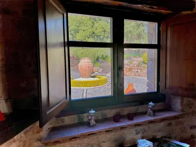 a window with a view of a vase in a yard at Apartment Superior-Doppelsuite mit Schlafsofa by Interhome in Bigues i Riells