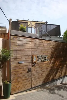 a wooden garage door with a sign on it at Holiday Home Haus Terrassa de Mar direkt am Strand by Interhome in Masnou