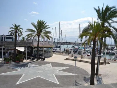 a star statue in front of a marina with palm trees at Holiday Home Haus Terrassa de Mar direkt am Strand by Interhome in Masnou