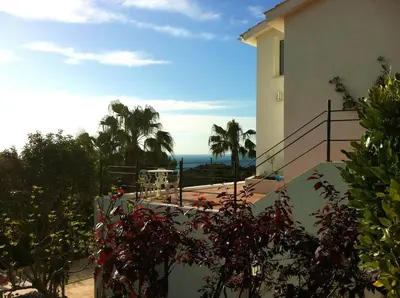 a building with a balcony with a view of the ocean at Las Buganvillas in Castelldefels