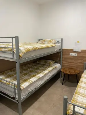 a room with two bunk beds and a table at Private room next to BCN airport in El Prat de Llobregat