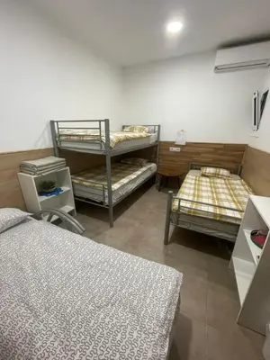 a room with three bunk beds in a room at Private room next to BCN airport in El Prat de Llobregat