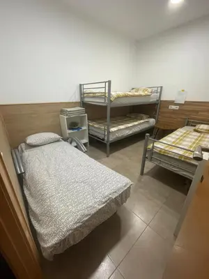a room with three bunk beds in a room at Private room next to BCN airport in El Prat de Llobregat