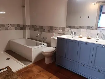 a bathroom with a tub and a toilet and a sink at Masía Can Janàs in Lliçà d'Amunt
