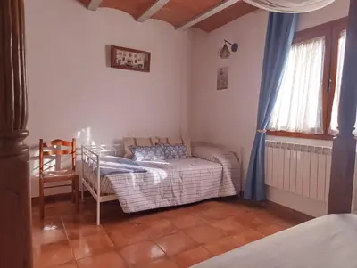 a living room with a couch and a chair at Masía Can Janàs in Lliçà d'Amunt