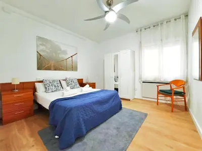 a bedroom with a bed and a chair in it at Apartamento en Vilassar de Mar, Costa de Barcelona in Vilassar de Mar