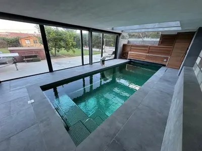a swimming pool in the middle of a house at Suite with Pool Barcelona in Vilassar de Dalt