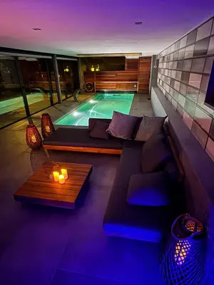 a swimming pool with a couch and a table at Suite with Pool Barcelona in Vilassar de Dalt