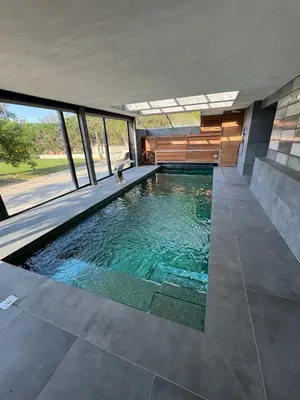 a swimming pool in the middle of a house at Suite with Pool Barcelona in Vilassar de Dalt