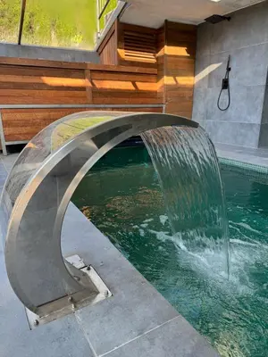 a pool with a water fountain in a house at Suite with Pool Barcelona in Vilassar de Dalt