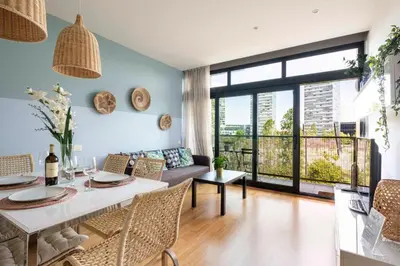 a living room with a table and a couch at Homenfun Barcelona Fira Gran Via in Hospitalet de Llobregat