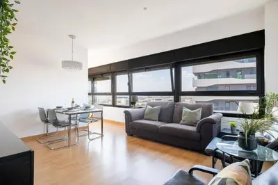a living room with a couch and a table at Homenfun Barcelona Fira Gran Via in Hospitalet de Llobregat