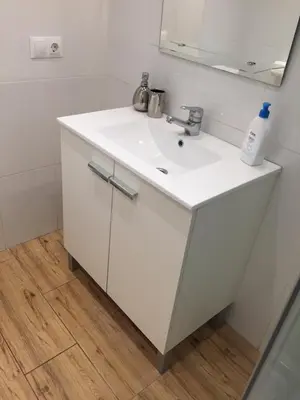 a bathroom with a white sink and a mirror at Indep suite 2 rooms in private villa views in Castelldefels