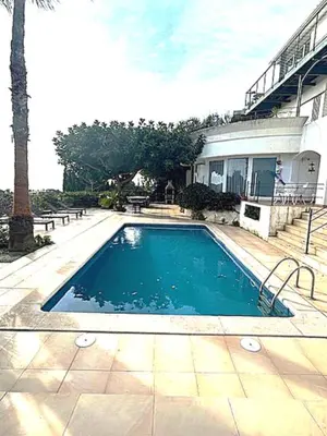 a building with a balcony with a view of the ocean at Independ room in villa with views 2 in Castelldefels