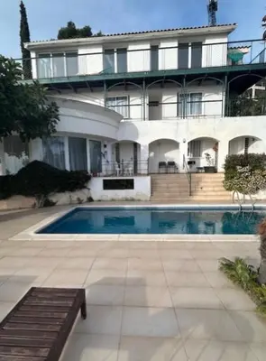 a swimming pool in front of a house at Independ room in villa with views 2 in Castelldefels
