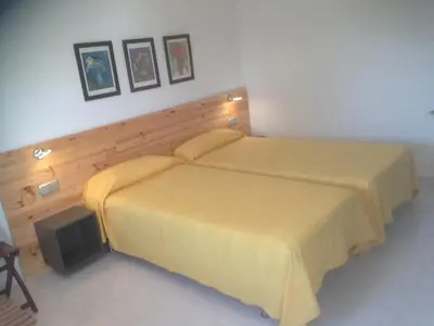 a house with a swimming pool in front of a building at Independ room in villa with views 2 in Castelldefels