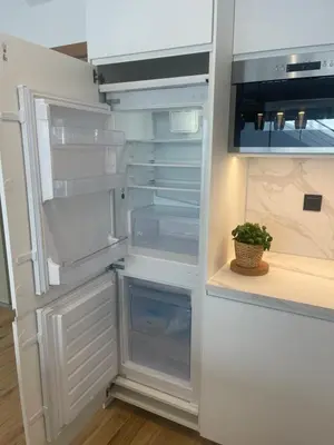 a refrigerator with its door open with a plant in it at Luxury sea view apartment near Sitges in Olivella