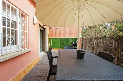 a table and chairs with an umbrella on a patio at Fantastic Penthouse in Barcelona