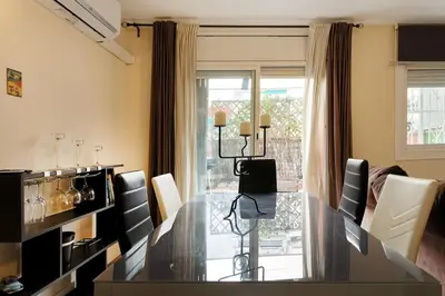a dining room with a glass table and chairs at Fantastic Penthouse in Barcelona