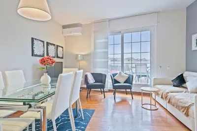 a living room with a glass table and chairs at Sarria Attic in Barcelona
